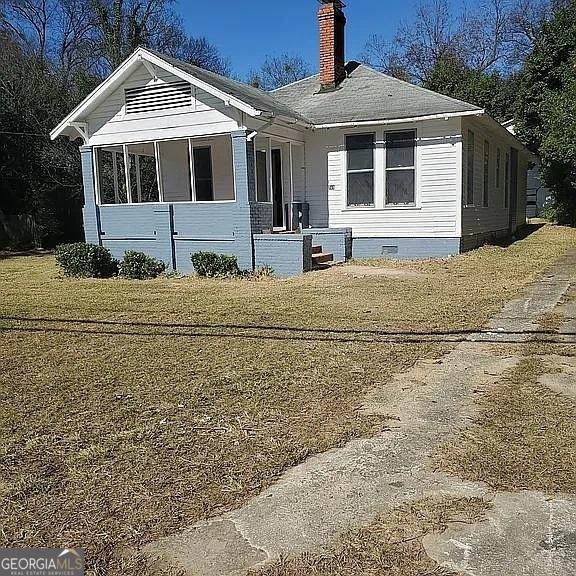749 Grenada Ter, Macon, GA 31206 - view of front of home with a chimney, crawl space, a front lawn, and covered porch