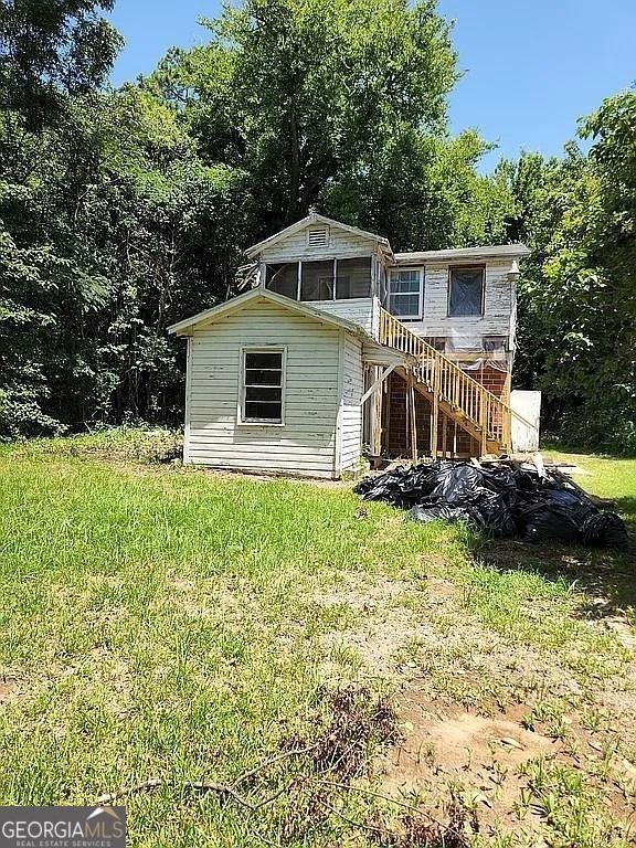 749 Grenada Ter, Macon, GA 31206 - view of front facade featuring stairway and a front yard