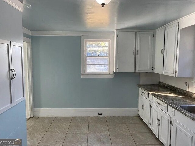 749 Grenada Ter, Macon, GA 31206 - kitchen featuring dark countertops, white cabinetry, and light tile patterned floors