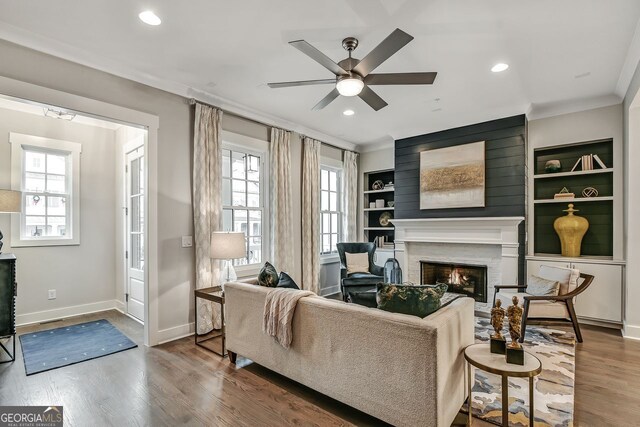 578 Brashy St, Woodstock, GA 30188 - living room featuring hardwood / wood-style flooring, ceiling fan, a healthy amount of sunlight, and crown molding