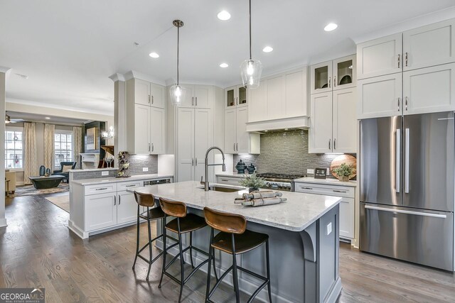 578 Brashy St, Woodstock, GA 30188 - kitchen with sink, hanging light fixtures, stainless steel refrigerator, a kitchen island with sink, and white cabinets