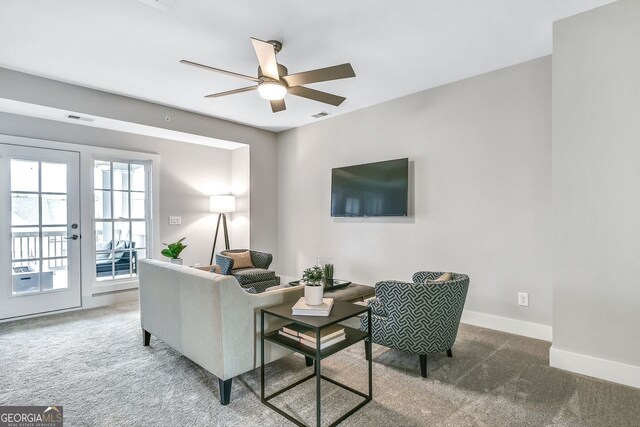 578 Brashy St, Woodstock, GA 30188 - living room with french doors, ceiling fan, and dark colored carpet