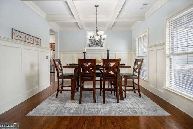 dining space featuring coffered ceiling, dark hardwood / wood-style floors, beam ceiling, and a chandelier