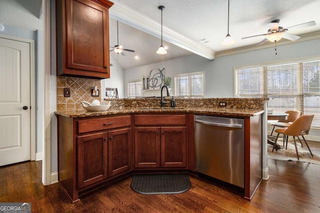 kitchen featuring sink, decorative light fixtures, dishwasher, kitchen peninsula, and stone counters