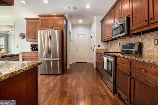 kitchen featuring crown molding, tasteful backsplash, dark hardwood / wood-style floors, stainless steel appliances, and light stone countertops