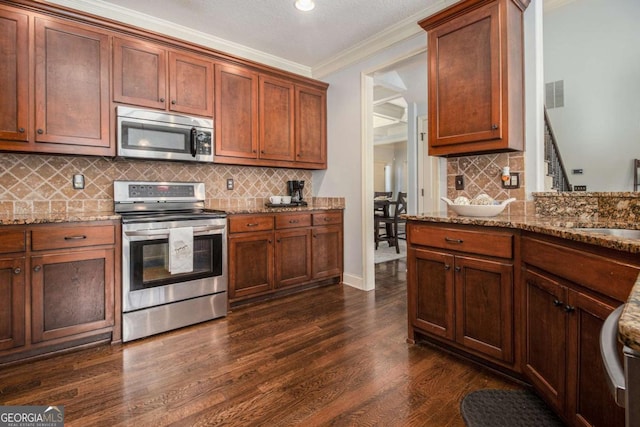 kitchen with light stone counters, ornamental molding, stainless steel appliances, and dark hardwood / wood-style floors