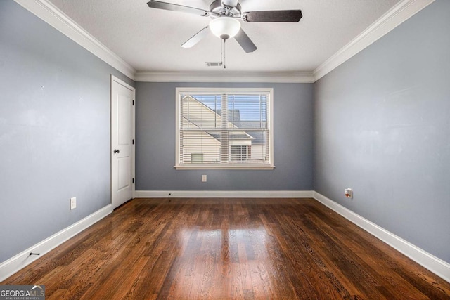 empty room featuring dark wood-type flooring, ceiling fan, and ornamental molding