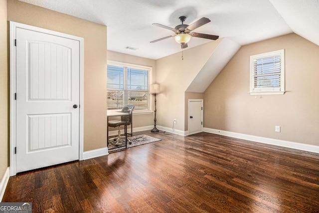 bonus room featuring vaulted ceiling, a healthy amount of sunlight, dark wood-type flooring, and ceiling fan