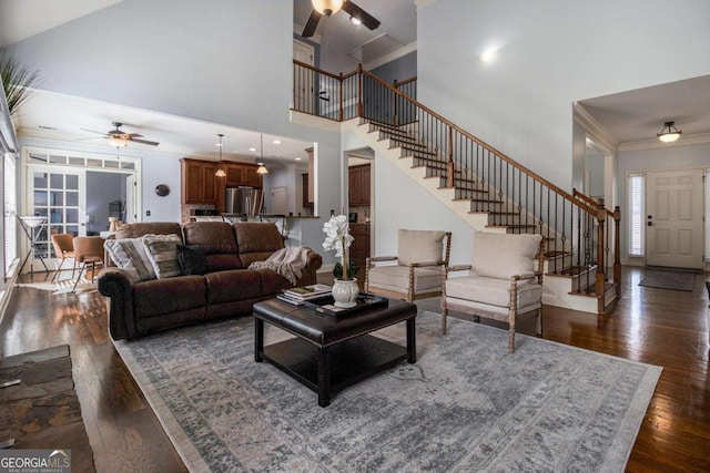 living room with ornamental molding, dark hardwood / wood-style floors, and ceiling fan