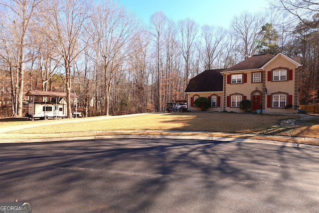 view of front of house featuring a front lawn and a carport