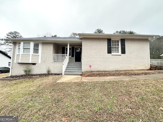 view of front of property with covered porch and a front yard