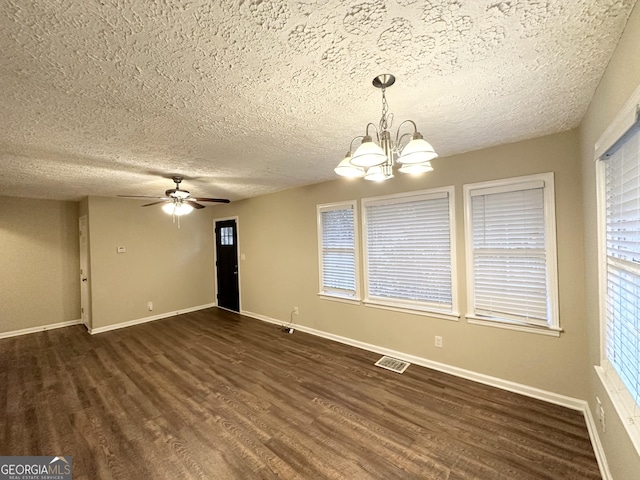 interior space featuring ceiling fan with notable chandelier, a textured ceiling, and dark hardwood / wood-style flooring