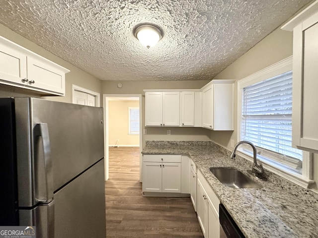 2922 Dale Pl, Decatur, GA 30032 - kitchen with dark wood-type flooring, sink, light stone counters, stainless steel refrigerator, and white cabinets