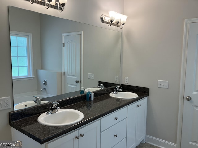 270 Bridgewater Ln SE, Darien, GA 31305 - full bath featuring double vanity, a bath, and a chandelier