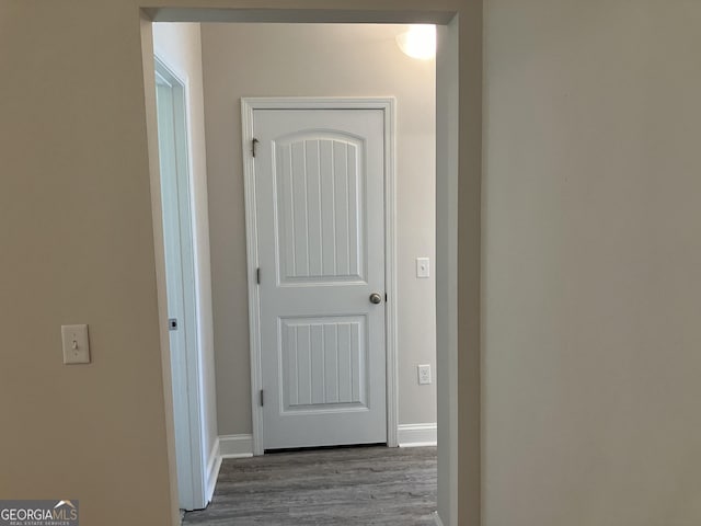 corridor with light hardwood / wood-style floors