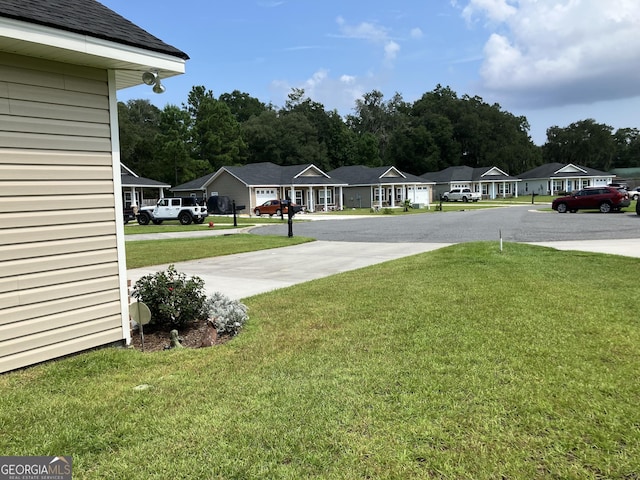 270 Bridgewater Ln SE, Darien, GA 31305 - view of green lawn with a residential view and driveway