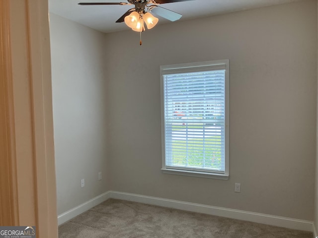 spare room with light carpet and ceiling fan