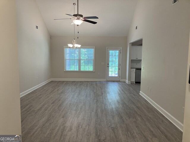 270 Bridgewater Ln SE, Darien, GA 31305 - unfurnished dining area with high vaulted ceiling, ceiling fan, dark wood-style flooring, and a chandelier