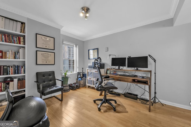 office space featuring ornamental molding, hardwood / wood-style flooring, and baseboards