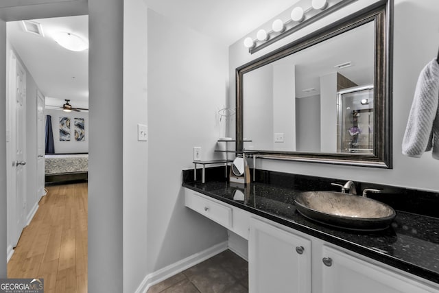 full bathroom featuring visible vents, a stall shower, vanity, ensuite bath, and baseboards