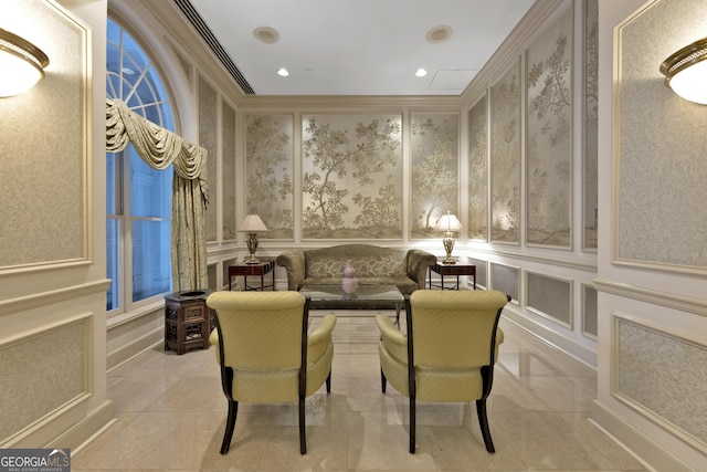 interior space with ornamental molding, recessed lighting, and a decorative wall