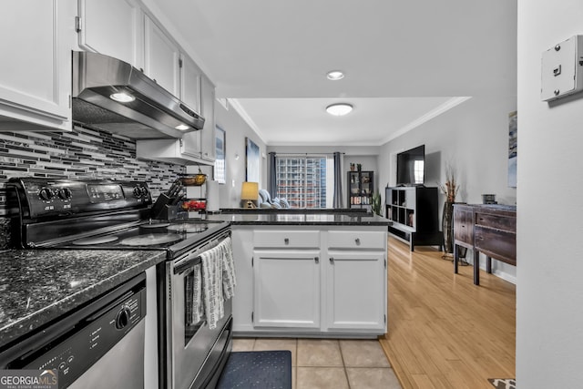 kitchen with a peninsula, appliances with stainless steel finishes, extractor fan, and crown molding