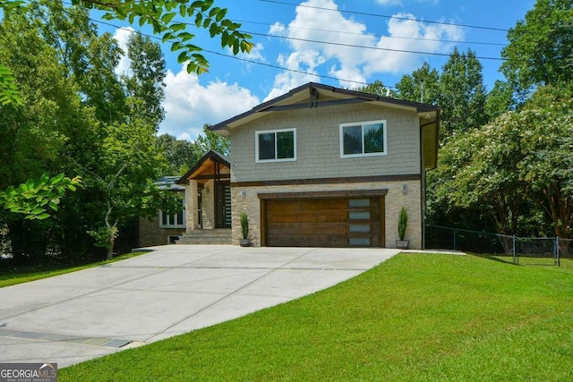 view of front of property with a garage and a front yard