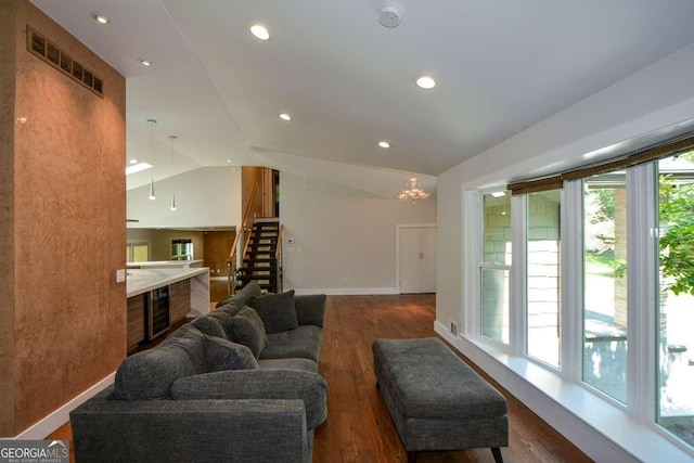 living room with lofted ceiling and dark hardwood / wood-style floors