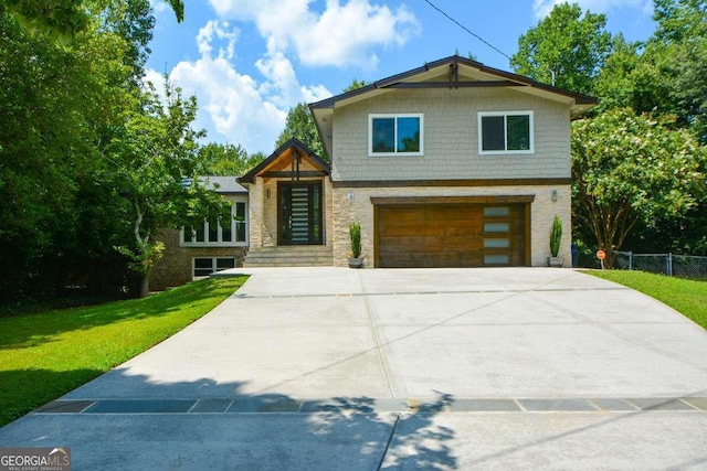 view of front of property with a garage and a front lawn