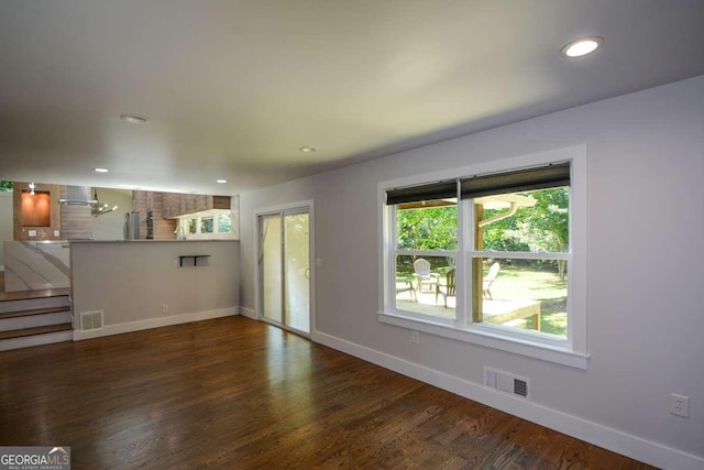 unfurnished living room featuring dark hardwood / wood-style flooring