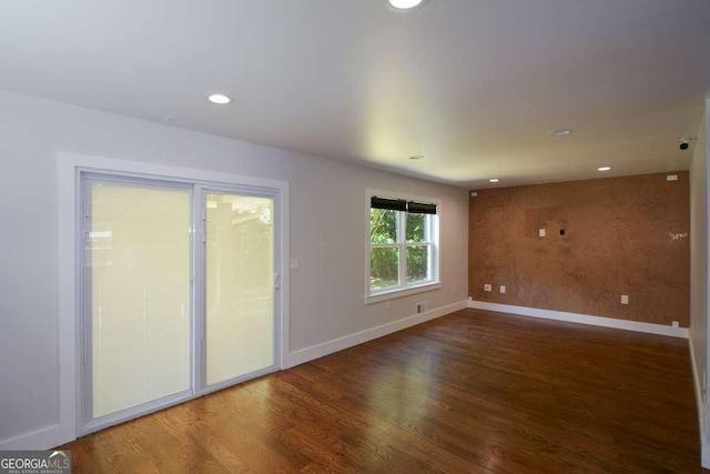 unfurnished room with wood-type flooring