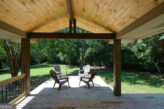 wooden terrace with a lawn