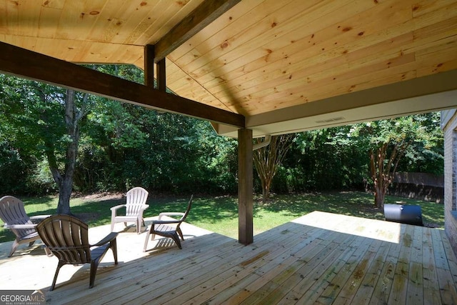 wooden terrace with a lawn