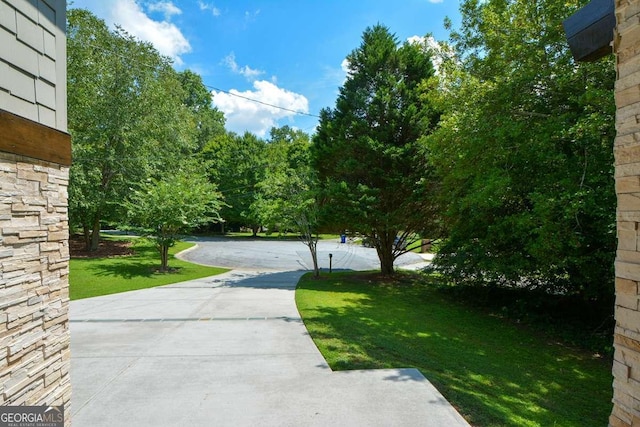 view of property's community with a lawn