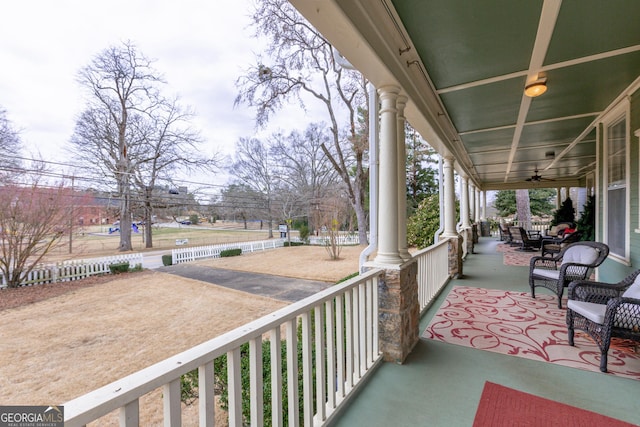 balcony with a porch and ceiling fan