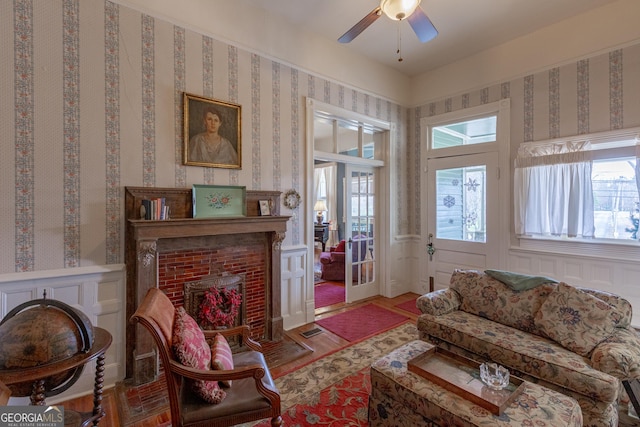 sitting room with a fireplace and ceiling fan