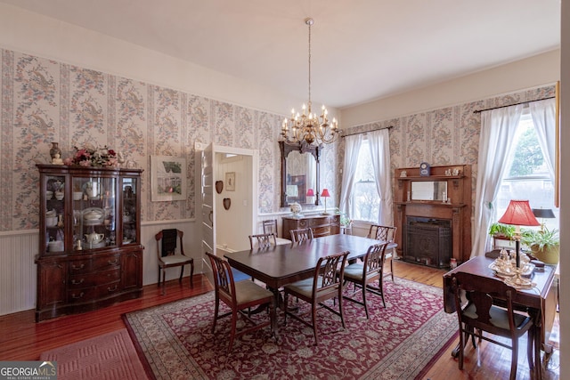 dining area with an inviting chandelier, wood-type flooring, and plenty of natural light