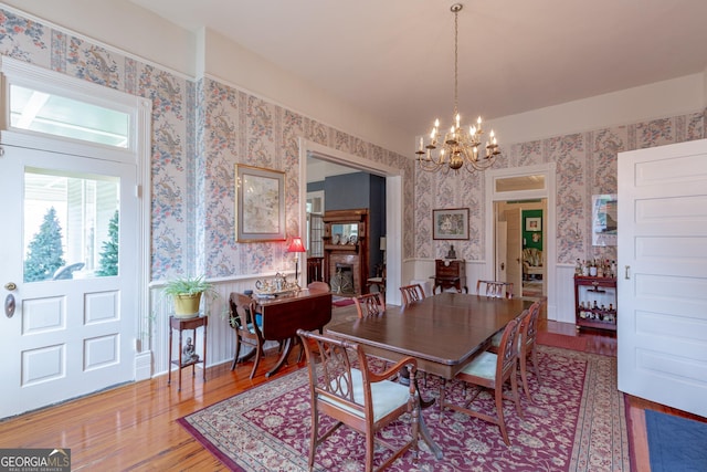 dining area with an inviting chandelier and wood-type flooring