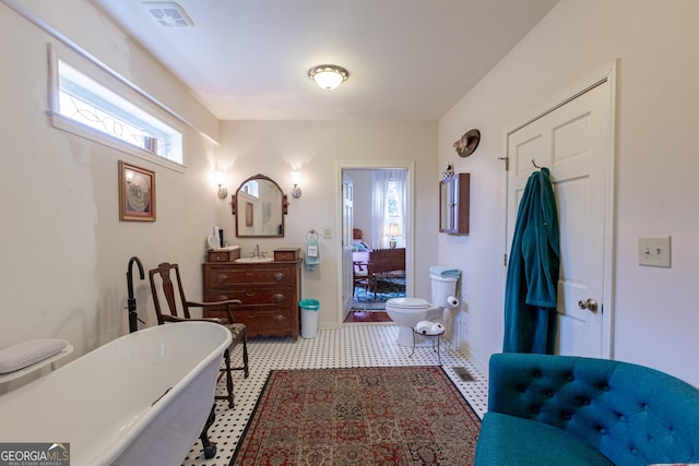 bathroom with vanity, toilet, and a bathtub