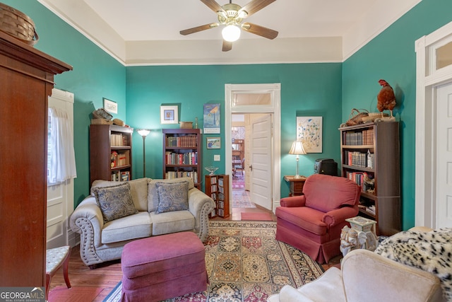 living room featuring hardwood / wood-style floors and ceiling fan