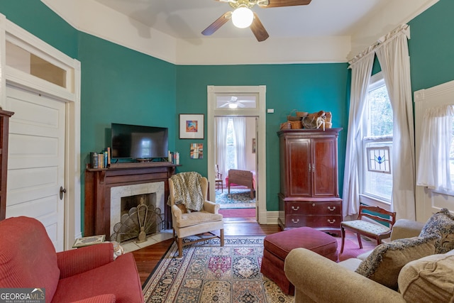 living room with hardwood / wood-style floors, a fireplace, and ceiling fan