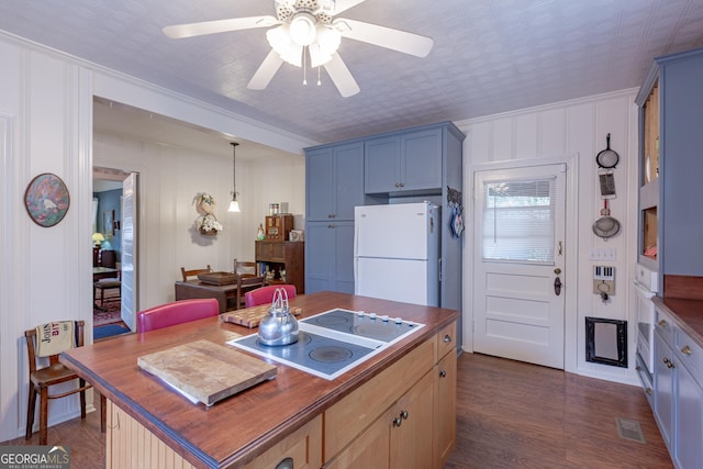 kitchen featuring white appliances, ceiling fan, butcher block counters, dark hardwood / wood-style floors, and decorative light fixtures