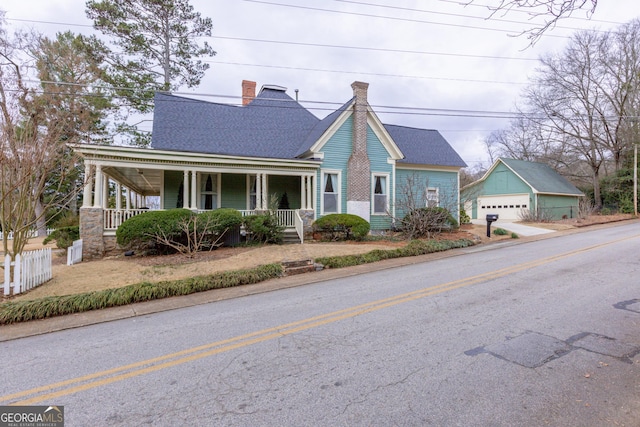 view of front of property with an outbuilding, a garage, and covered porch