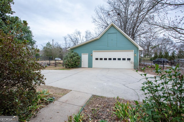 view of side of property featuring an outbuilding and a garage