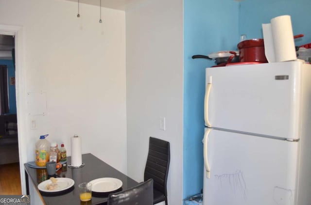 kitchen with hardwood / wood-style floors and white fridge