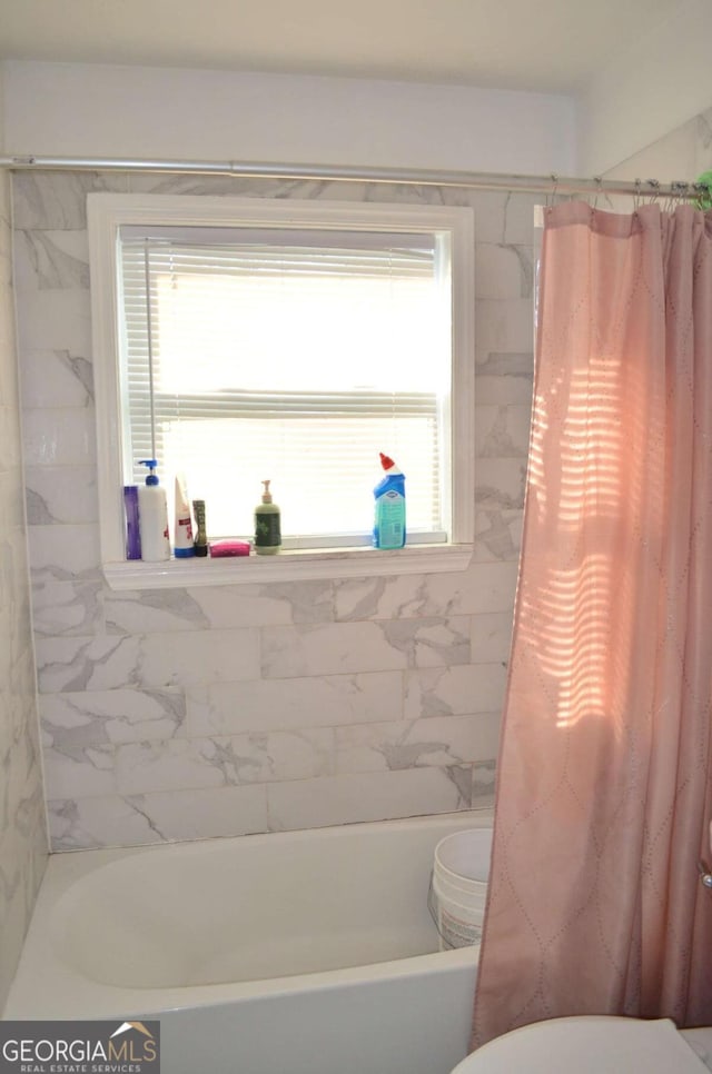 bathroom with shower / bathtub combination with curtain