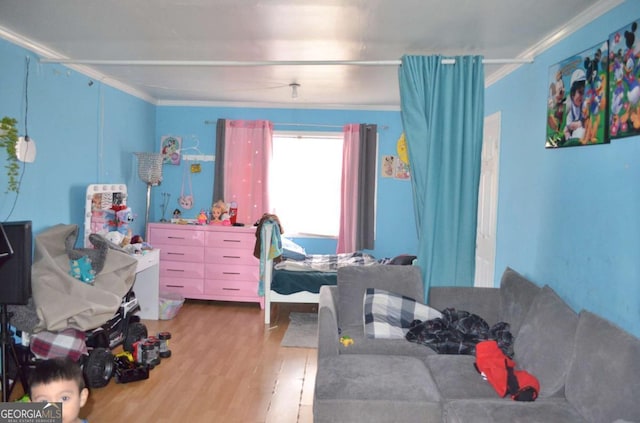 bedroom with ornamental molding and hardwood / wood-style floors