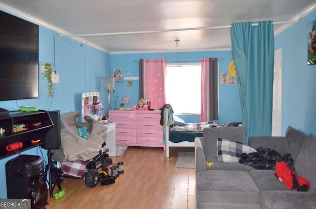 bedroom with ornamental molding and wood-type flooring