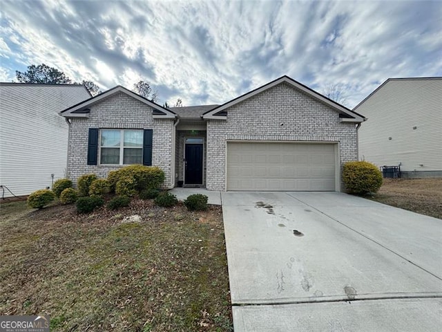 ranch-style house with an attached garage, driveway, a front yard, and brick siding