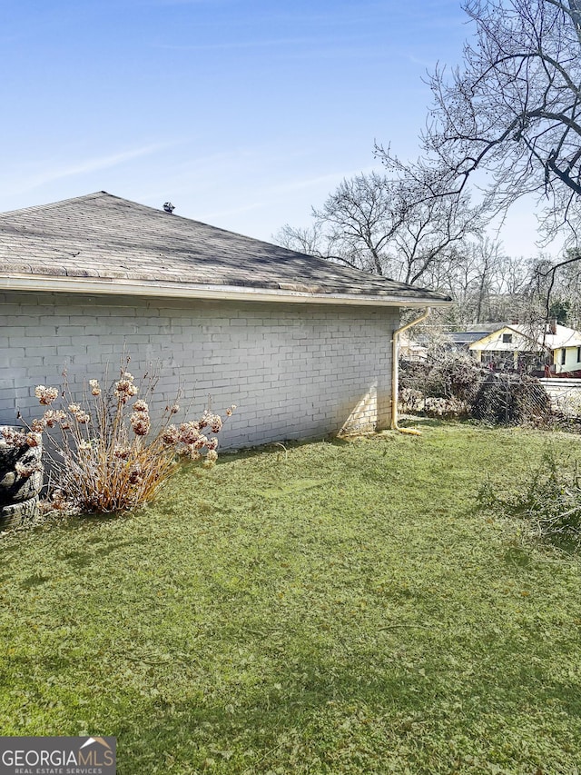 view of side of home featuring a yard
